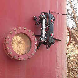 The Marvel robot climbing up a steel tank.