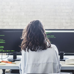 female worker at two computer screens