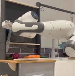 The ALAN robot doing chores in a kitchen.