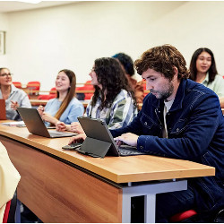 college students at laptop computers in a classroom