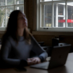 student in mindfulness exercise in a darkened classroom