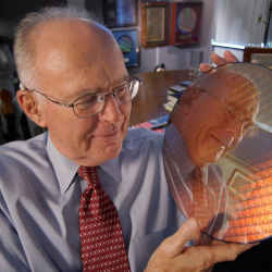 Gordon Moore holding a silicon wafer