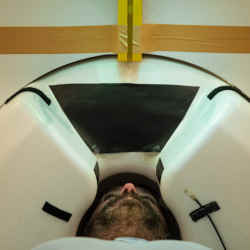 A researcher demonstrates the brain-scanning magnetoencephalography device at New York University.