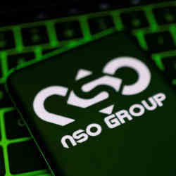 The NSO Group logo on a smartphone lying on a keyboard. 