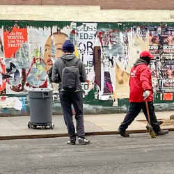 A trash barrel robot, controlled remotely by Cornell researchers, follows a janitor through the streets of Manhattan.