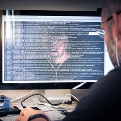 coder's face reflected in computer display