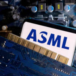 A smartphone with a displayed ASML logo placed on a computer motherboard.