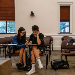 two students study in a classroom