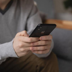 user thumb typing on a smartphone