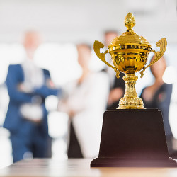 business people observe a trophy