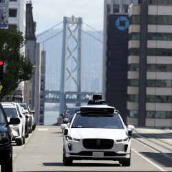 A Waymo autonomous vehicle driving along California Street in San Francisco.
