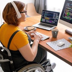 user in a wheelchair works at a computer