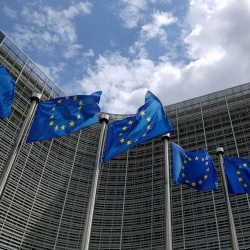 European Union flags flutter outside European Commission headquarters in Brussels, Belgium.
