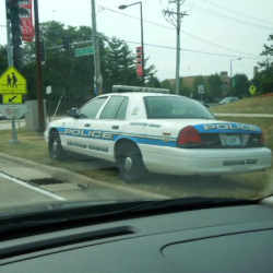 A police car parked near an intersection.