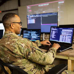 A service member with the 175th Cyber Operations monitors cyberattacks during Exercise Southern Strike at Camp Shelby, MS.