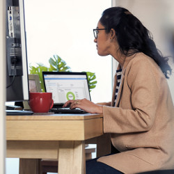 remote worker sits at a computer on a desk