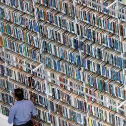 A visitor walks past shelves of books at the Mohammed bin Rashid Library in Dubai.