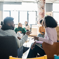 college students conversing in a classroom