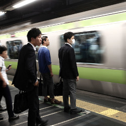 Japanese businessmen on a subway platform