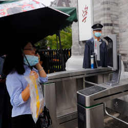 A woman in front of facial recognition camera-controlled gates at Peking University in Beijing, China.