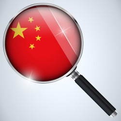 Chinese flag under a magnifying glass