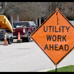 road sign stating 'Utility Work Ahead'