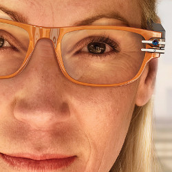 closeup of person wearing stylish glasses that include a camera