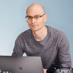 UC Berkeley Professor Pieter Abbeel sitting at a laptop computer