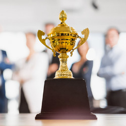 winner's trophy with contenders in the background