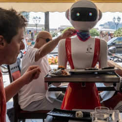 A robot waitress serving patrons.