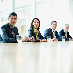 four job interviewers sitting behind a table