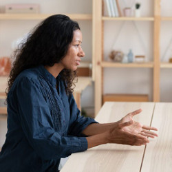 woman on one side of a negotiating table