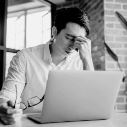 stressed worker at a laptop computer