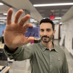 Researcher Sam Kriegman shows one of the robots.