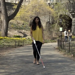 user with a WeWalk smart cane