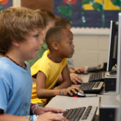 Elementary school students learning on computers. 