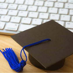 graduation cap next to a keyboard