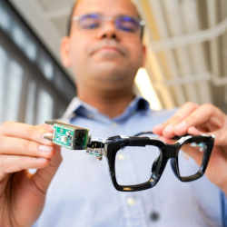 Saif Mahmud, a doctoral student in the field of information science, with PoseSonic glasses.