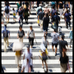 crowd of people using a crosswalk in Osaka, Japan