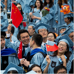 Chinese students wave flags at a ceremony at Columbia University 