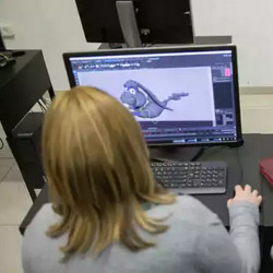 Haredi woman at a computer display studying computer science