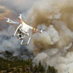 A drone flying over a wildfire.