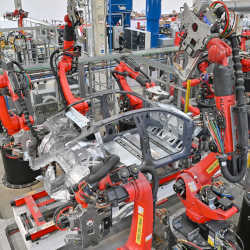 Robots weld the body of a Model Y electric vehicle at Teslas factory near Berlin.