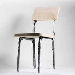 A chair whose metal frame was 3D-printed. 