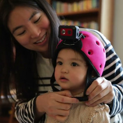 mother fastening a child's head-mounted camera