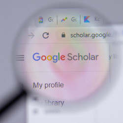 magnifying glass over Google Scholar logo